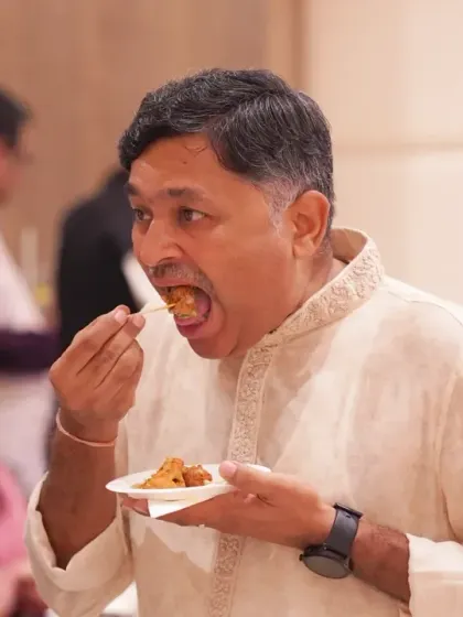 A guest savoring a bite of food. I believe in capturing all aspects of the wedding experience, including the delicious culinary journey.