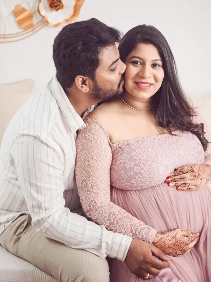 A sweet kiss for the glowing mom-to-be. We love capturing these close-up, affectionate moments that show the couple's excitement and love.