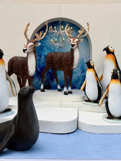 We create magical winter wonderlands for holiday events and themed parties. This setup features our collection of realistic, life-sized arctic animal props, including polar bears, reindeer, penguins, and a seal, set against a snowy backdrop with illuminated archways.