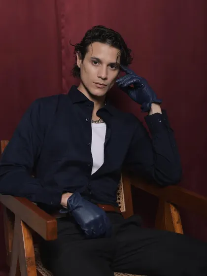 A solo shot from the Cairon campaign, where I styled the model in a dark shirt, trousers, and leather gloves for a moody, cinematic feel.