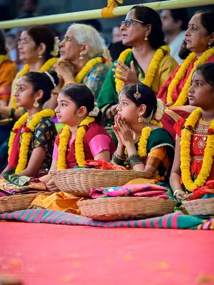 Young girls dressed in traditional attire, participating in the Shat Chandi Homa. Their presence adds a special innocence and grace to the ceremony.