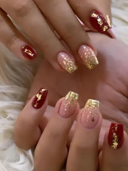 A festive and glamorous set combining deep red, sparkling gold glitter, and gold foil flakes for a rich, celebratory look.