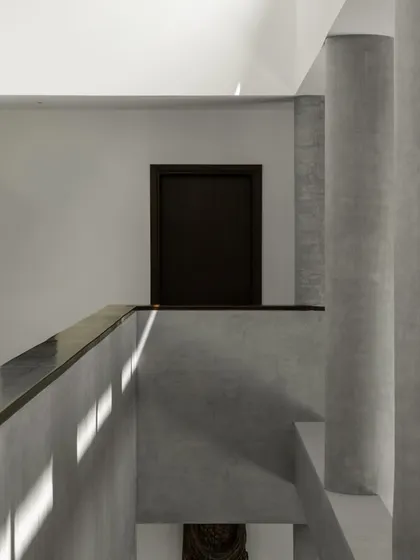 Interior views of the gallery-like spaces, where concrete columns and walls create a neutral yet powerful backdrop for art. The play of light from skylights and windows animates the surfaces.