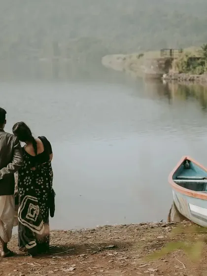 The couple looking out over the lake together, symbolizing their shared future, with a boat nearby hinting at their journey.