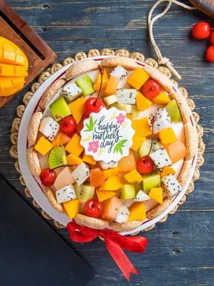 Our Exotic Fruit Cake is a fresh and vibrant option for any celebration. It's topped with a colourful assortment of seasonal fruits like kiwi, dragon fruit, mango, and cherries.