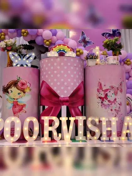 More details from Poorvisha's party, showing the custom-wrapped pedestals and light-up name display. The polka dot and bow design adds a playful touch.