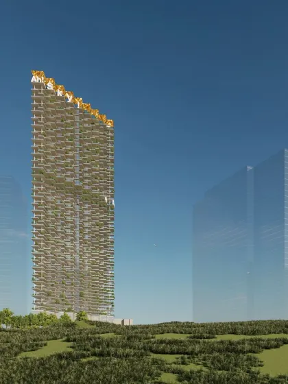 A full view of the "Ah! Sky!" tower, showcasing its slender profile and the unique texture created by the staggered, green-filled balconies. The design aims to create a complete neighborhood in the sky, with all the amenities of a traditional community.