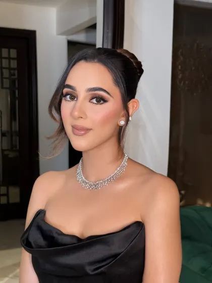 A closer look at the makeup, showing the clean lines of the eyeliner and the subtle contouring that defines her features beautifully.