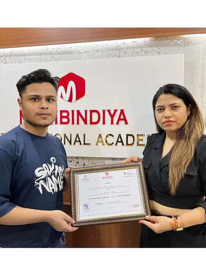 A male student proudly holding his certificate, proving that passion for beauty knows no gender.