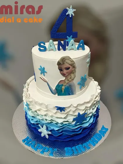 This two-tier Frozen cake is a showstopper, with blue ombre ruffles on the bottom tier and an edible image of Elsa on top. Snowflake decorations complete this chilly, beautiful design.