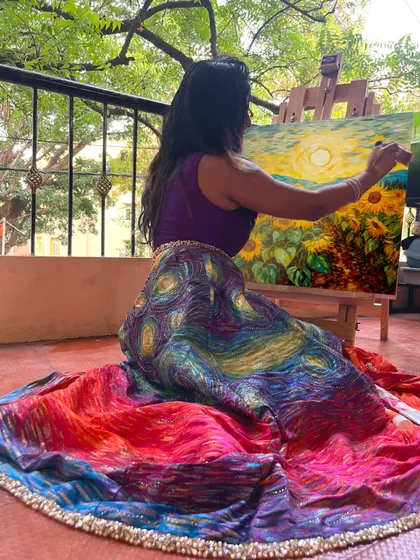 Here I am, lost in the process of painting a sunflower field against a sunset, bringing the vision for my lehenga to life stroke by stroke on an easel in my balcony.