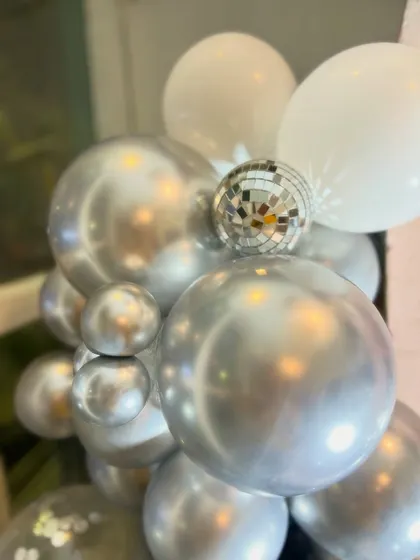 We added mini disco balls to the balloon arrangements for that extra bit of sparkle and fun, perfectly fitting the party theme.