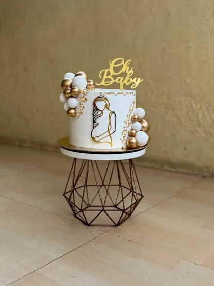 A clean shot of our popular white and gold "Oh Baby" cake. This order came all the way from the US for a delivery in Thane.