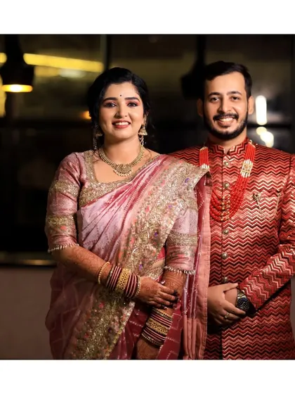 A classic portrait of the engaged couple. Their coordinated pink and red outfits look stunning, and their happy smiles show their excitement for the future.