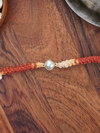 A flat-lay of the Kundan Rakhi. It's an elegant and understated option for your brother.