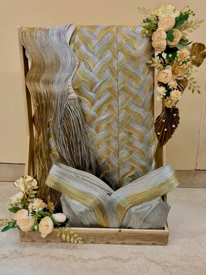 This is how I pack traditional wedding attire for a bride's trousseau. The garments are artfully arranged in a wooden tray and decorated with complementary floral bouquets.