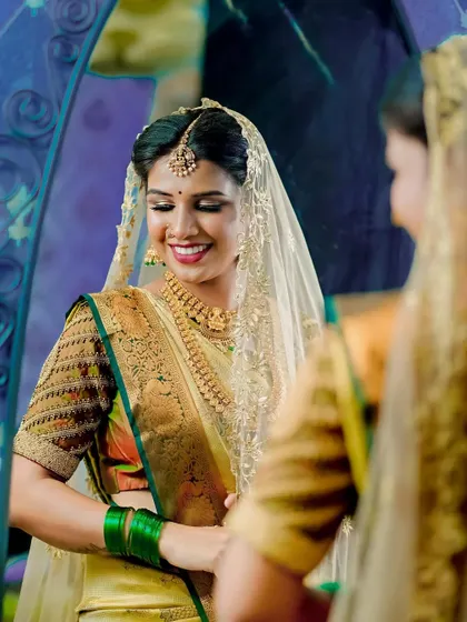 A beautiful bride admiring her final look in the mirror. My goal is to enhance your natural beauty so you feel confident and look like the best version of yourself.