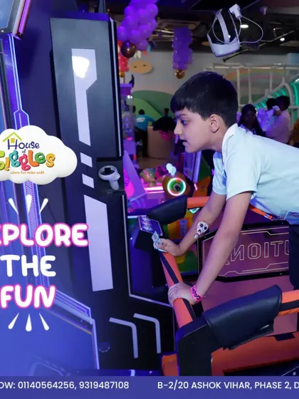 Explore the fun in our glowing arcade zone. This young player is completely focused on his game, surrounded by the neon lights and exciting atmosphere of our gaming area.