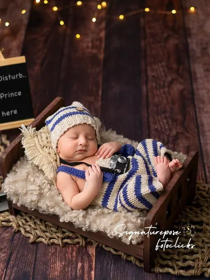 A sleeping prince in his little bed. The soft lighting and cozy props create a serene and peaceful image.