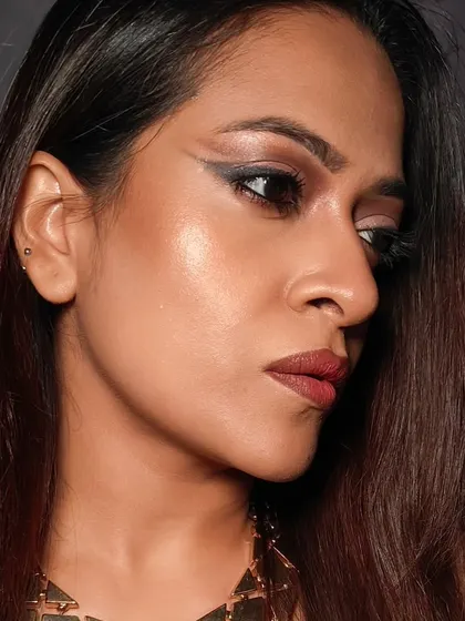 A close-up of the graphic eyeliner and shimmery eyeshadow. This shows the detail and precision that goes into creating a statement eye.