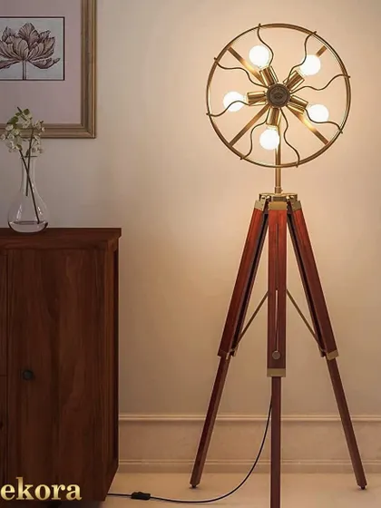 Make a bold statement with this unique fan-shaped tripod lamp. Featuring five exposed bulbs in a circular brass frame, this piece is functional art, ideal for industrial or eclectic interiors that need a conversation starter.