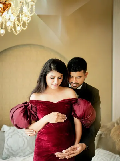 An elegant and loving portrait of the couple, beautifully lit to highlight their connection and the gorgeous velvet dress.
