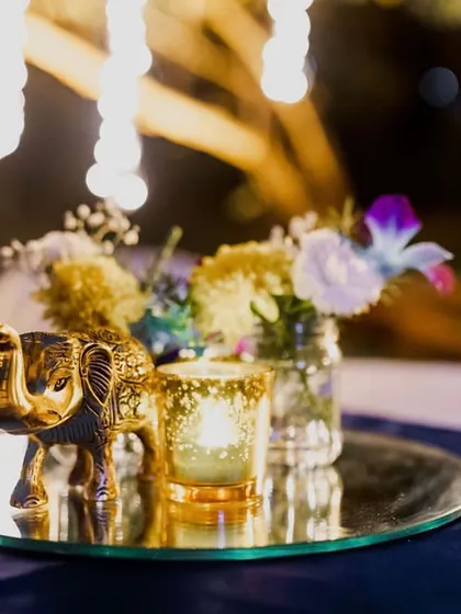 A small brass elephant figurine adds a touch of traditional elegance and good fortune to this beautiful tabletop decor.