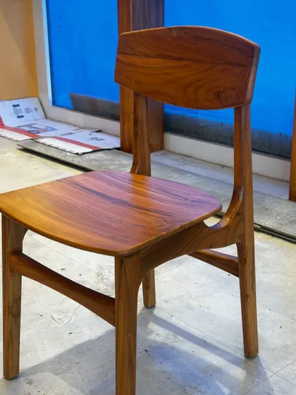 This simple yet elegant dining chair was part of a custom furniture set I created for a cafe in JP Nagar. Made entirely of solid teak wood, its clean lines and ergonomic design are perfect for high-traffic commercial use.