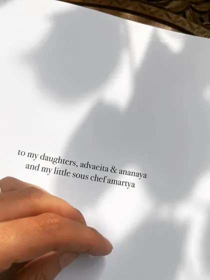 A dedication page from a family cookbook: "To my daughters, Advaeita & Ananaya and my little sous chef Amartya."