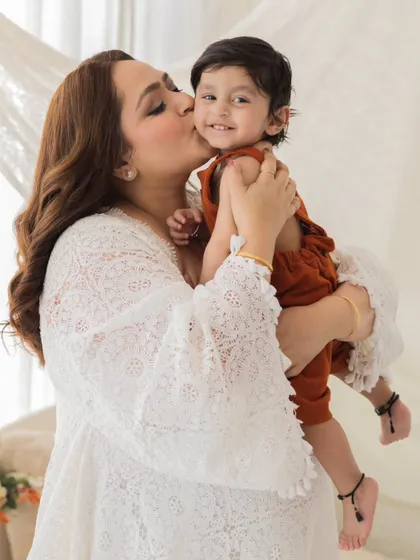 A kiss full of love. This candid shot of a mother kissing her smiling toddler is a perfect example of the genuine, happy moments we love to capture.