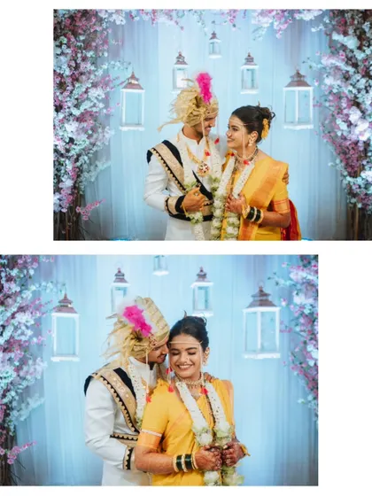 A couple posing against a dreamy, lantern-lit backdrop during their wedding ceremony.