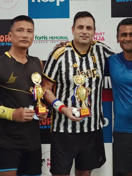 Winners from different age and skill categories posing with their trophies. My events are structured to be inclusive, with categories for 30+, 35+, and 40+ to ensure fair and exciting matches for all.