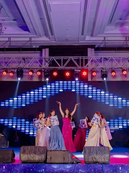 Using props to spell out the bride's name is a great way to personalize a performance. Here, the bridesmaids are getting ready for their big moment.