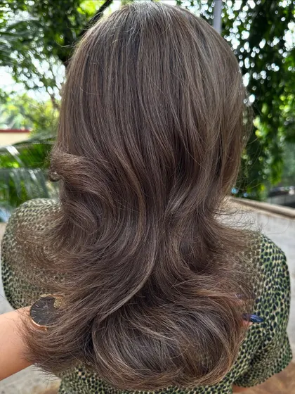 The final result of her ash-toned holiday hair.