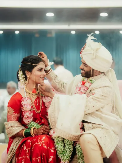 A beautiful moment during the wedding ceremony where the groom is applying sindoor to the bride.