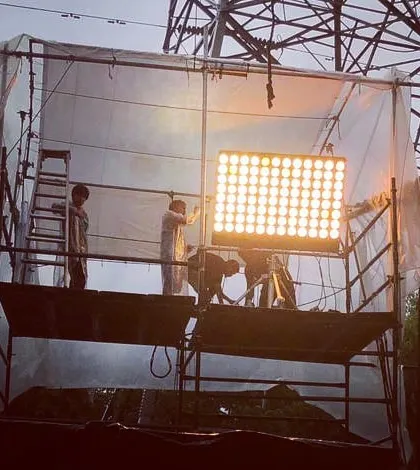 Here, our team sets up a 96 bank 'Half Wendy' light on an 8x8 foot tower. This beast of a conventional fixture provides a massive wall of light and requires specialized rigging and large format 8x8 foot color temperature blue frames.