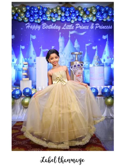The daughter from the family set, posing in her golden net gown. The big bow at the waist is her favorite part.