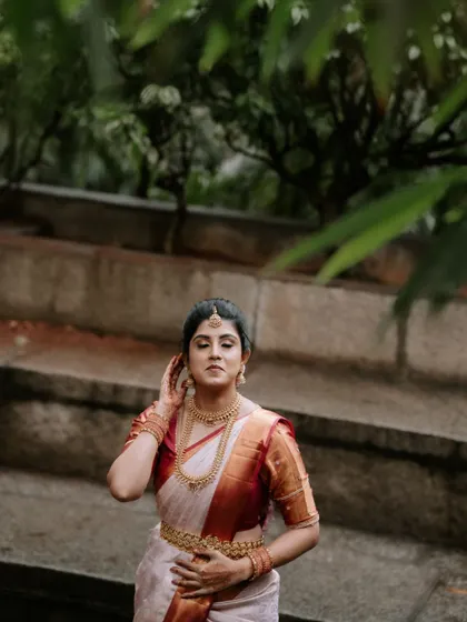 A moment of quiet reflection for the bride. This close-up captures her adjusting her hair, a simple gesture filled with grace.