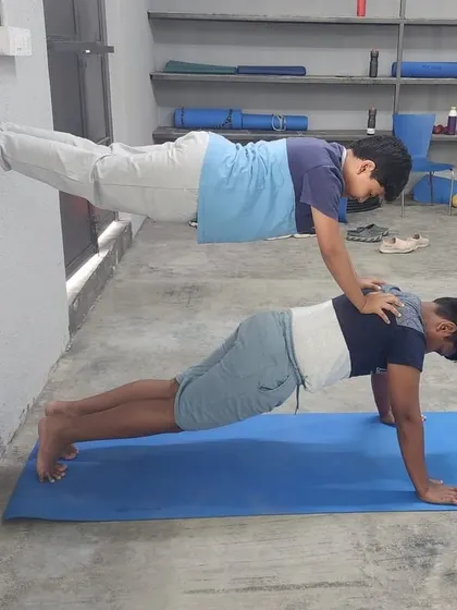 This wall-assisted double plank is a great way to build up to the full, unassisted version of the pose.