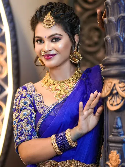 Another angle of the royal blue blouse, showing the fine detailing of the embroidery that covers the sleeves and neckline.