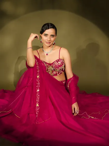 This shot from a fashion series shows a modern take on bridal glamour. The sleek, side-parted hair and diamond jewellery are paired with a makeup look that is both sophisticated and striking.