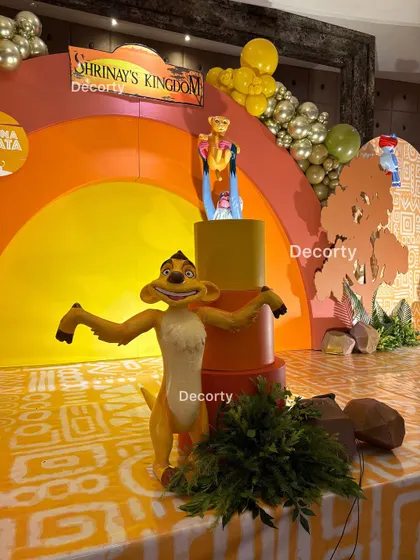 A detailed shot of the Timon prop on stage, adding personality and fun to the birthday decor.