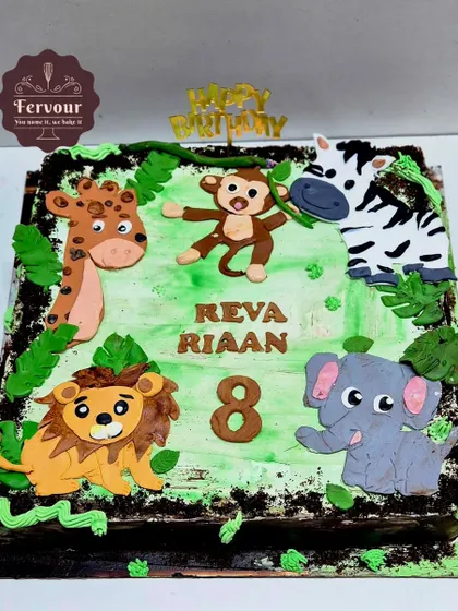 A fun jungle animal cake for an 8th birthday. This square chocolate cake is decorated with cute, flat fondant animals like a lion, monkey, and zebra on a green "jungle floor."