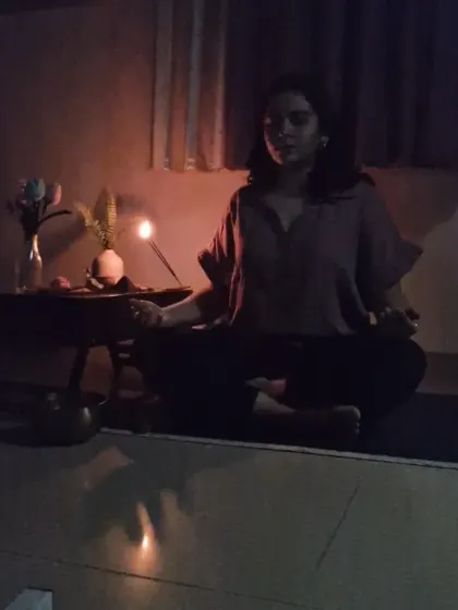Sometimes the practice is quiet and internal. Here, in a space lit only by candles, I connect with my breath. This is a form of somatic practice, listening to the body's subtle language in stillness.