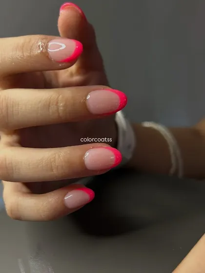 A close-up view of the neon pink French tip set. The precision of the lines and the quality of the finish ensure a salon-perfect look every time.