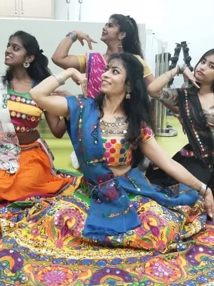 Striking a pose in our colorful Garba outfits before the show begins.