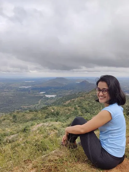 A bright smile against a backdrop of clouds and hills. This picture perfectly captures the joy of a Sunday morning spent in nature.