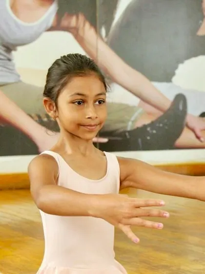With focused attention, a young dancer practices her arm positions. Even at the primary level, we begin to instill the precision that is core to classical ballet.