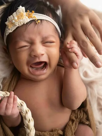 Even a little cry can make for a powerful and real photograph. This newborn's expression is full of emotion, a genuine moment captured in the studio.