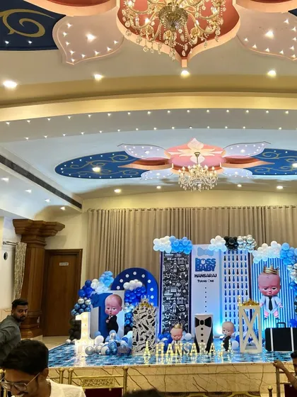 A wide shot of the Boss Baby themed stage decoration, showing the scale of the setup in a large venue.